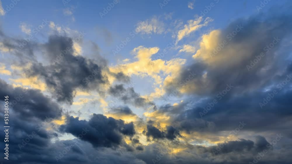 Rolling dark clouds in the blue sky. Yellow clouds and black clouds landscapes at sunset. 4k time lapse. Rolling dark clouds in the blue sky. Yellow clouds and black clouds landscapes at sunset. 4k time lapse.