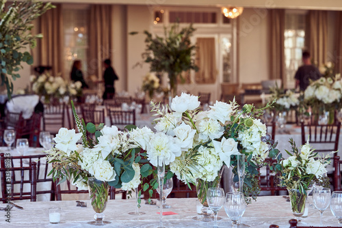 Luxury Beautiful Stylish Romantic Greens and Whites Fresh Flower decorations of guest tables at the wedding venue dinner celebration set up