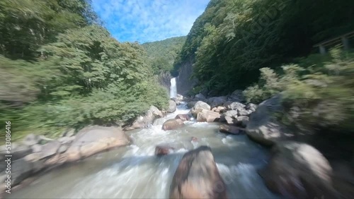 Waterfall in forest in Niigata Japan by FPV drone photo