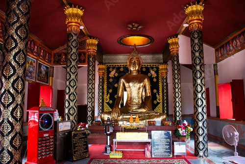 Ancient buddha statue in antique ubosot for thai people travelers travel visit respect praying blessing holy mystery worship of Wat Phra Kaew temple at Chainat on May 27, 2020 in Chai Nat, Thailand photo