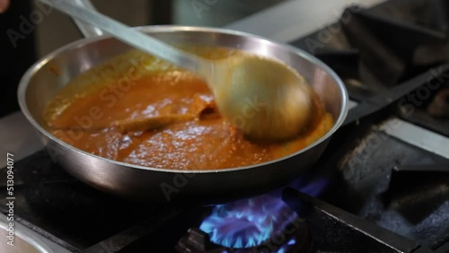 Leg of lamb smashed with fangs in a cauldron of spiced sauce. in Indian cooking