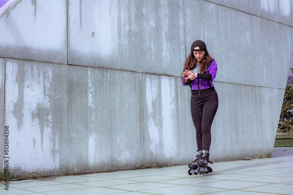 young sporty woman practicing inline skating in an urban setting young sporty woman practicing inline skating in an urban setting