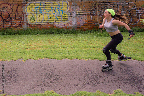 young sporty woman practicing inline skating in an urban setting