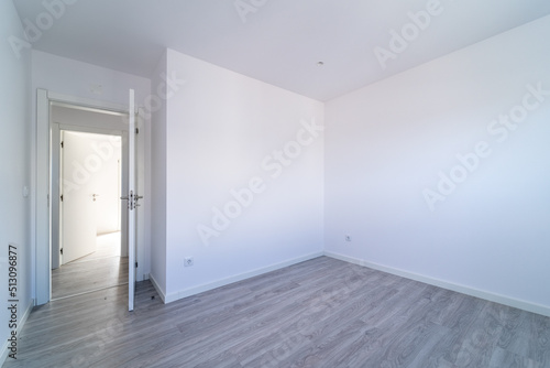 Empty room with gray wooden floating  laminate flooring. House interior  wide bedroom or living room space. New home  apartment or house. Wood floor. Real state and property management
