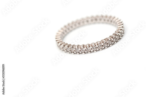 Silver color ring with decorative stones on a white background.