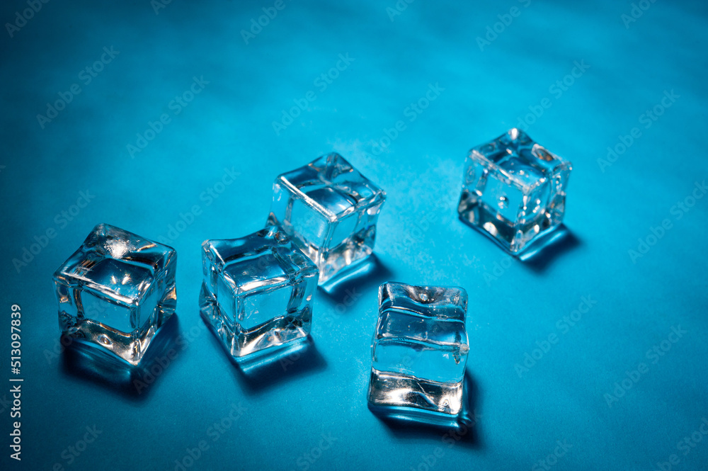 Clear ice cubes for cooling drinks on a blue background.