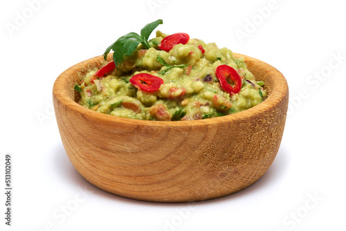 Wooden bowl of guacamole dip sauce isolated on white background