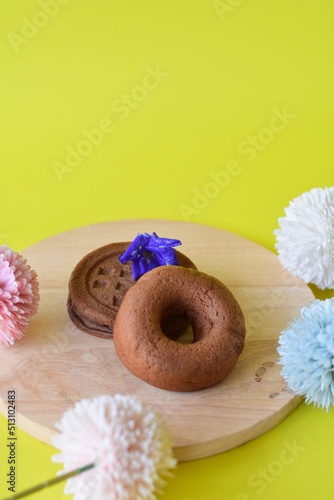 chocolate donuts on a wooden plate