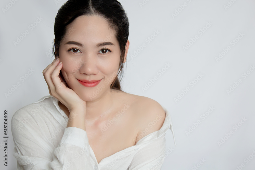 Asian beautiful woman looking to camera with smile and happiness and touching her clean face . Skin Beauty and Facial Asian beautiful woman looking to camera with smile and happiness and touching her clean face . Skin Beauty and Facial