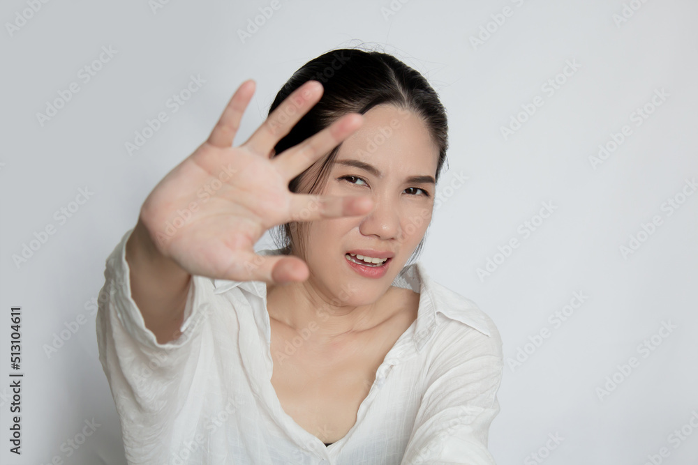 Asian beautiful woman raise hand to refuse something with scared depressed and fear Asian beautiful woman raise hand to refuse something with scared depressed and fear