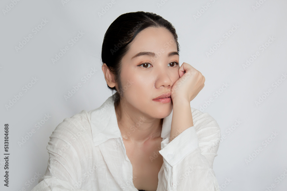 Asian beautiful woman touch her cheek and look away with feeling worried. Metal concept and Broken heart. Asian beautiful woman touch her cheek and look away with feeling worried. Metal concept and Broken heart.