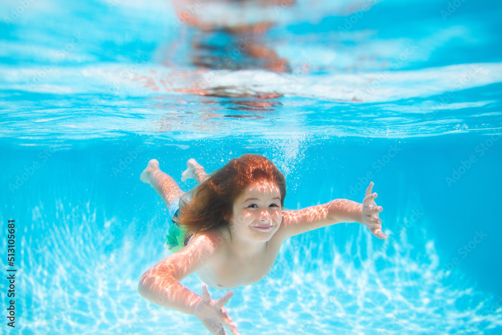 Child swim and dive underwater in the swimming pool. Summer kids activity, watersports.