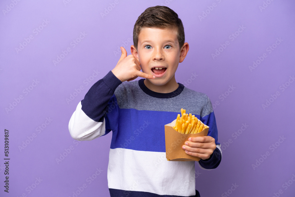 Little boy holding fried chips isolated on purple background making phone gesture. Call me back sign Little boy holding fried chips isolated on purple background making phone gesture. Call me back sign