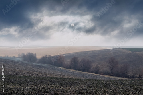 Plowing field prepared for planting crops in spring. Autumn field in cloudy weather