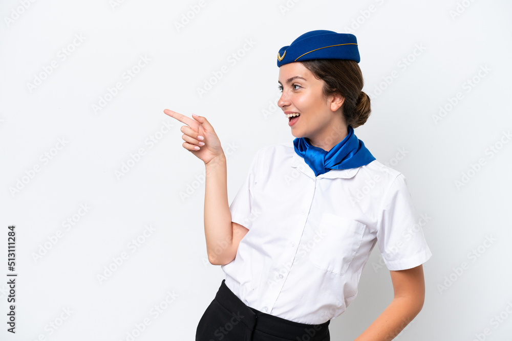 Airplane stewardess caucasian woman isolated on white background pointing finger to the side and presenting a product Airplane stewardess caucasian woman isolated on white background pointing finger to the side and presenting a product