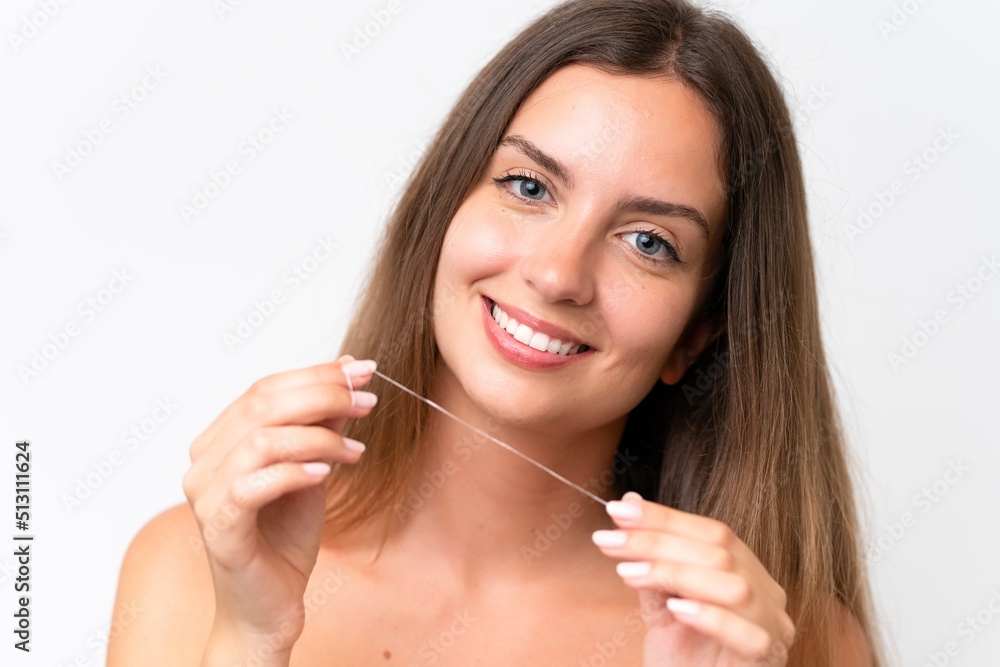 Young caucasian woman isolated on white background using dental floss with happy expression. Close up portrait Young caucasian woman isolated on white background using dental floss with happy expression. Close up portrait