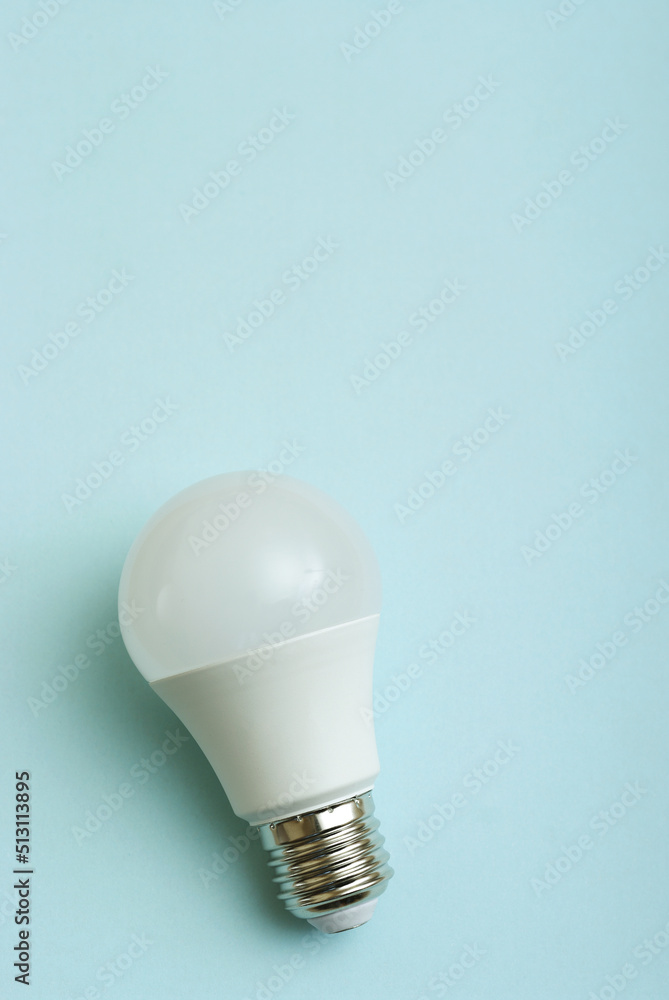White economy light bulb on blue background with free copy paste space for text. White economy light bulb on blue background with free copy paste space for text.