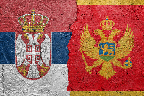 Serbia and Montenegro - Cracked concrete wall painted with a Serbian flag on the left and a Montenegrin flag on the right stock photo