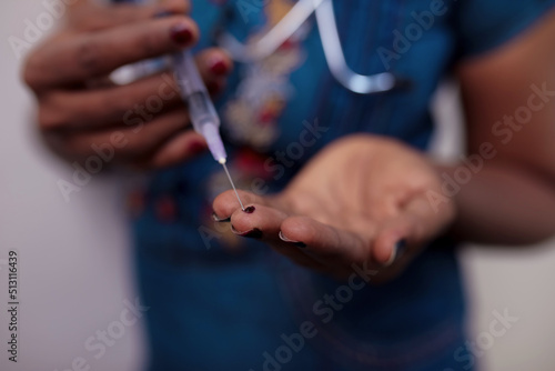 Young woman hitting syringe Drug mage of using illegal drugs with a syringe