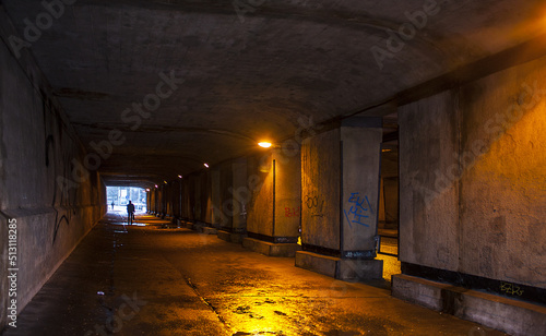 Road under a bridge with artificial lighting