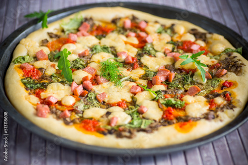 cooked pizza with mushrooms and vegetables with cheese and spices