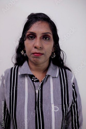 Closeup portrait of a face of the young woman, focusing on camera  