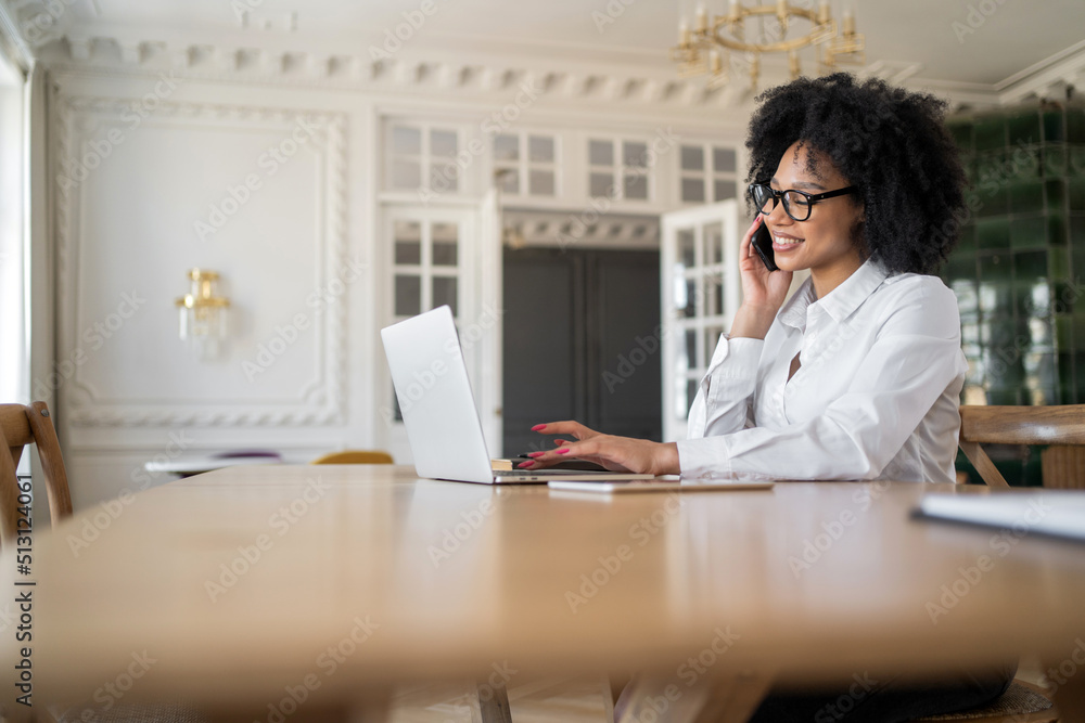 Manager woman with glasses uses laptop makes notes on work , office workplace coworking space Manager woman with glasses uses laptop makes notes on work , office workplace coworking space