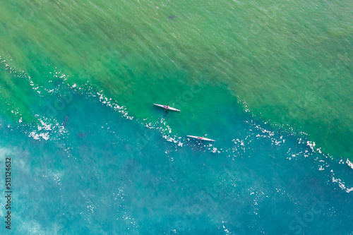  Aerial view of two white kayaks, rowing in the sea with turquoise water © luciano