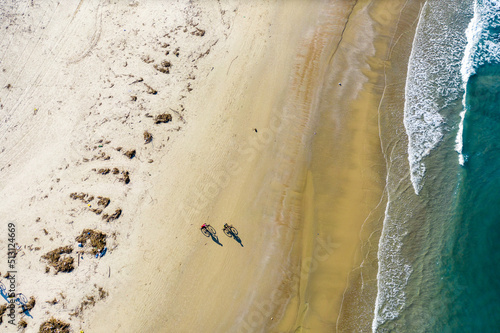 Aerial view of two men riding bicycles at the beach