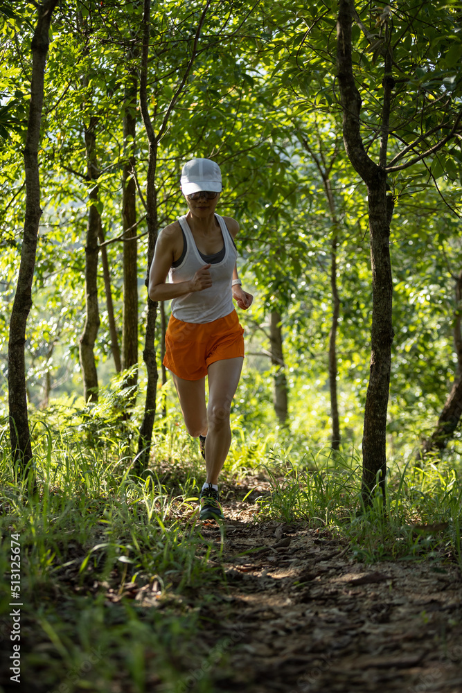 Woman runner running on forest trail. Woman runner running on forest trail.