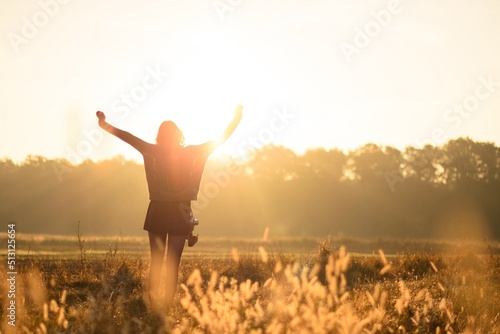 woman in the field during sunrise