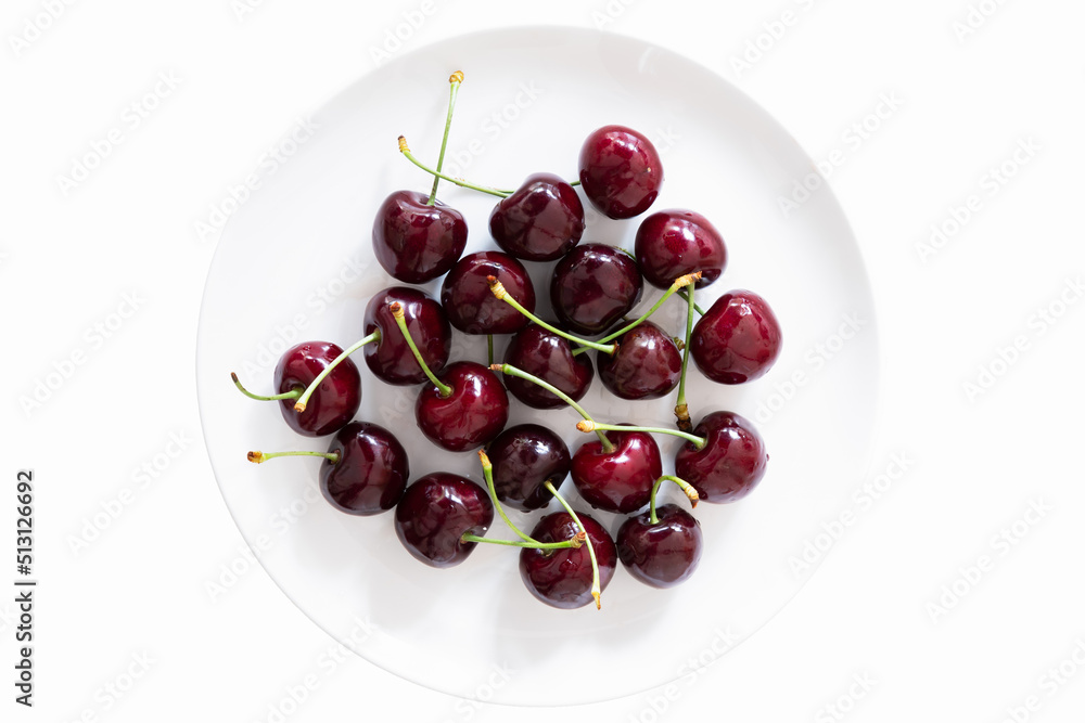 Fresh red cherries on a saucer isolated on a white background. Fresh red cherries on a saucer isolated on a white background.