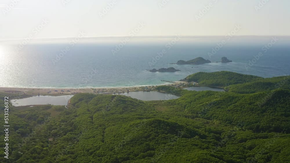 Drone view of a beautiful sandy beach with clear water at dawn. Seascape. Triozerye Bay, Primorsky Krai Drone view of a beautiful sandy beach with clear water at dawn. Seascape. Triozerye Bay, Primorsky Krai