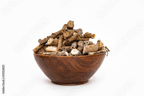 Ayurvedic herb or folk medicine Hemidesmus indicus or Nannari or Indian sarsaparilla dried roots in wooden bowl photo