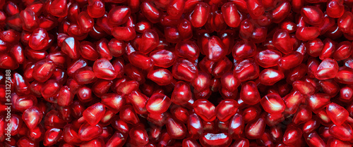 Banner of red Background of Grain Red Grenades. Big Ripe Red Granets or Garnets. Fruits of Red Ripe Pomegranate. Vegetarian Concept, Organic Vitamins. Organic and Benefit Garnet Fruit