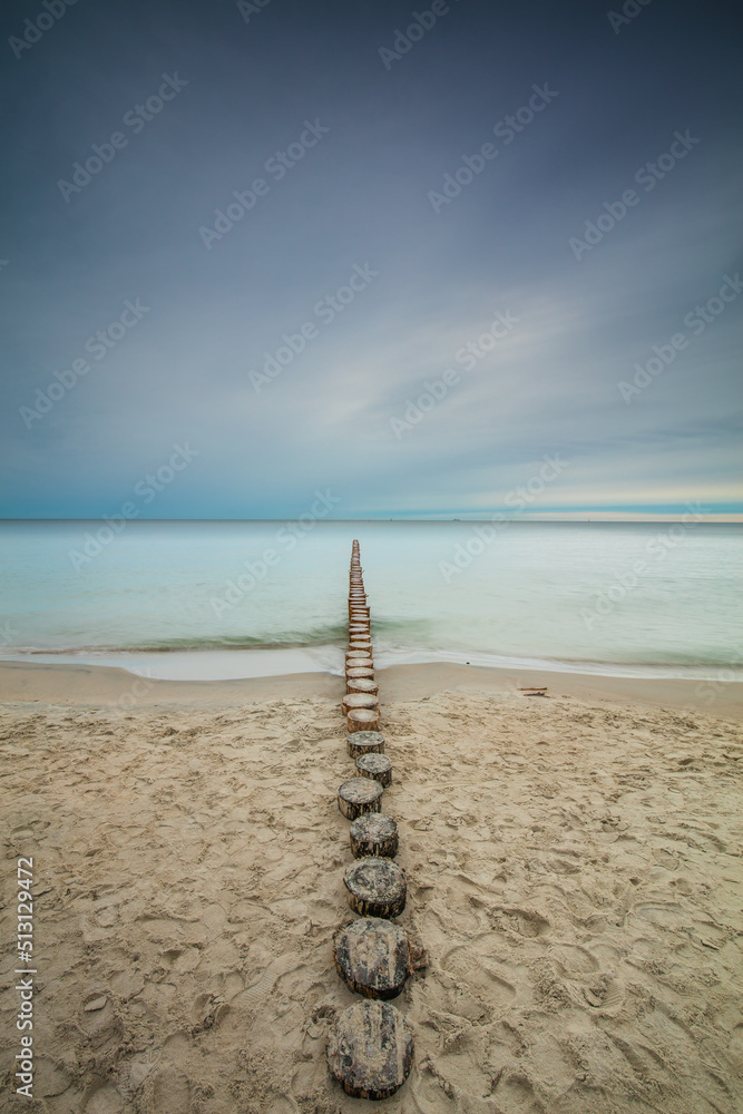Amazing sunrise over the sea in Chalupy. seascape with breakwater