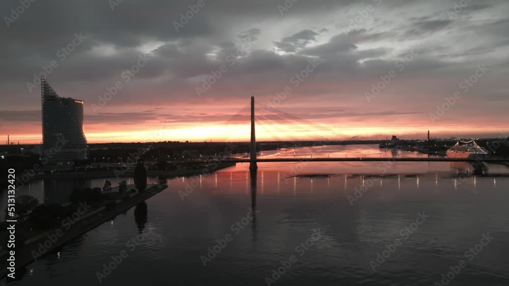 Magical sunset over Riga city at night. Cable-stayed bridge in Riga or Vansu tilts during sunset. Beautiful Riga city view at night. Magical sunset over Riga city at night. Cable-stayed bridge in Riga or Vansu tilts during sunset. Beautiful Riga city view at night.