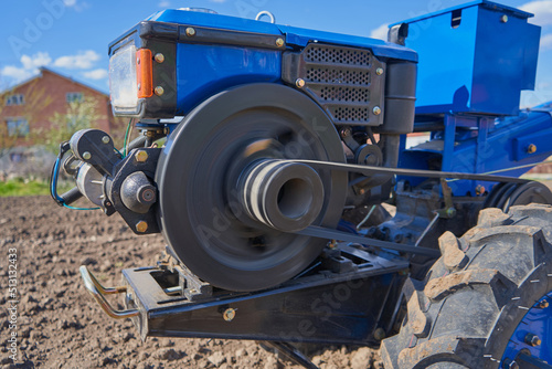 Obraz na plátně spinning tractor flywheel,the work of the engine of a two-wheeled tractor in the