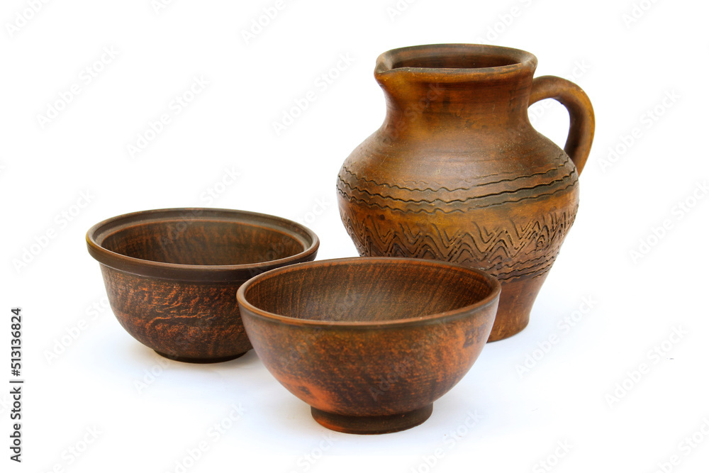 Set of kitchen utensils jug and several earthenware plates Set of kitchen utensils jug and several earthenware plates