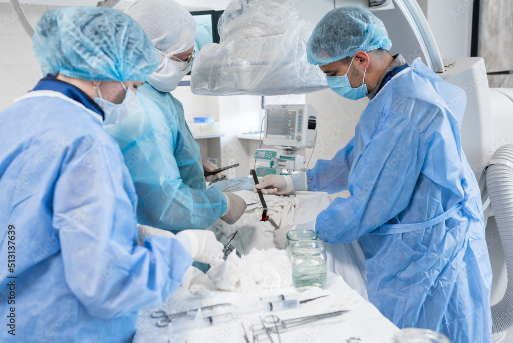 an assistant in the operating clinic pushes the incision with instruments to introduce electrodes to the heart. cardiovascular surgery. The doctor is going to insert electrodes to the heart an assistant in the operating clinic pushes the incision with instruments to introduce electrodes to the heart. cardiovascular surgery. The doctor is going to insert electrodes to the heart