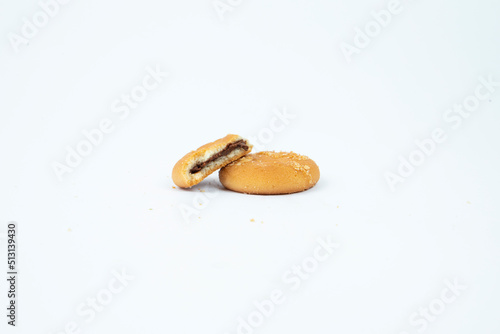 round ginger biscuit with crumbs and bite missing, isolated on white 