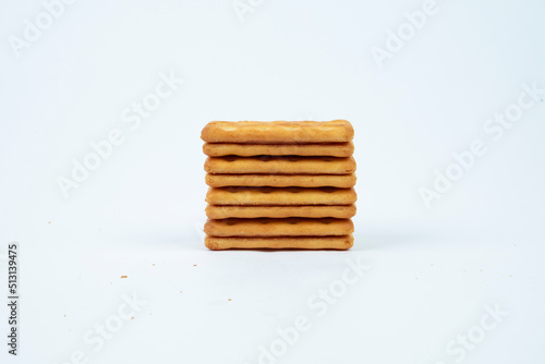 Stack of Saltine crackers isolated on white background.