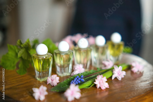 Female perfume bottle with flowers on the table