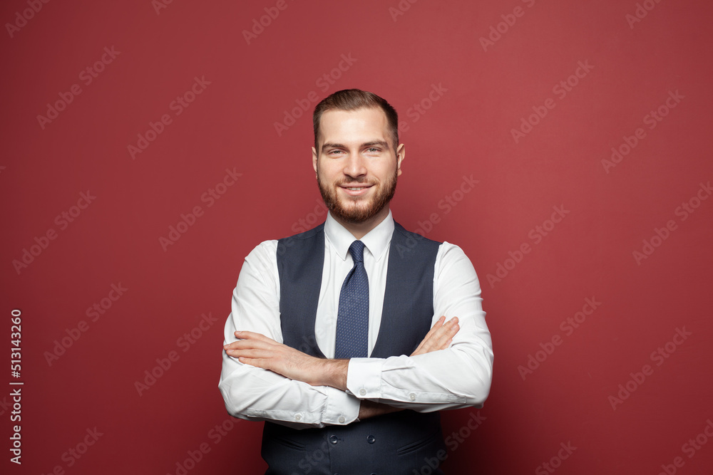 Successful optimistic businessman standing with arms crossed and looking ahead satisfied on red background Successful optimistic businessman standing with arms crossed and looking ahead satisfied on red background