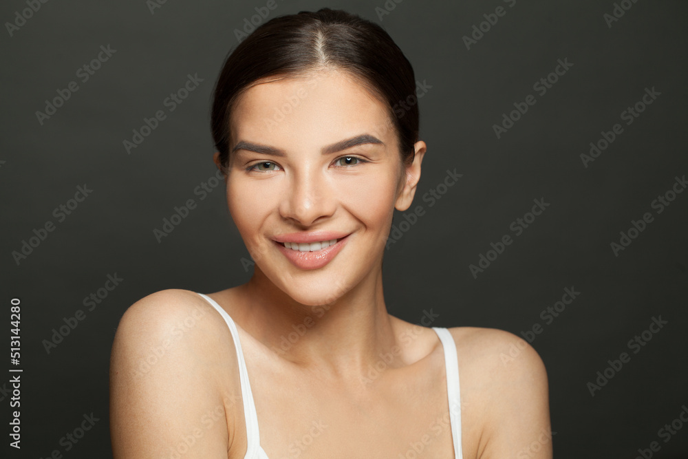 Portrait of happy smiling woman brunette model with clean fresh skin. Facial treatment, cosmetology, beauty and spa concept Portrait of happy smiling woman brunette model with clean fresh skin. Facial treatment, cosmetology, beauty and spa concept