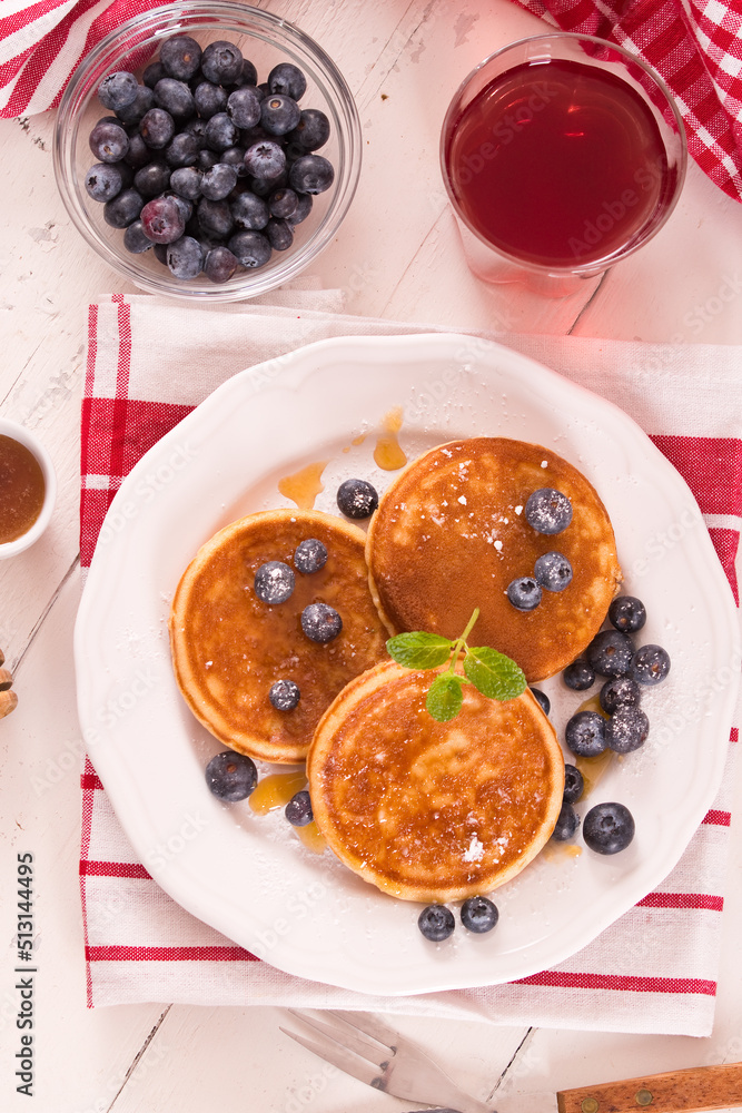 Pancakes with blueberries and chocolate cream.