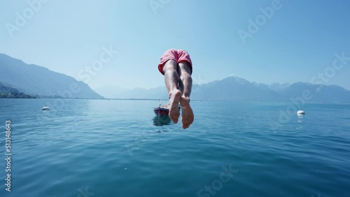 Man diving into lake person running on pier and dives into water