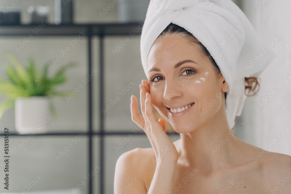 Face of beautiful european lady which applies cream. Attractive feminine girl beauty routine. Face of beautiful european lady which applies cream. Attractive feminine girl beauty routine.