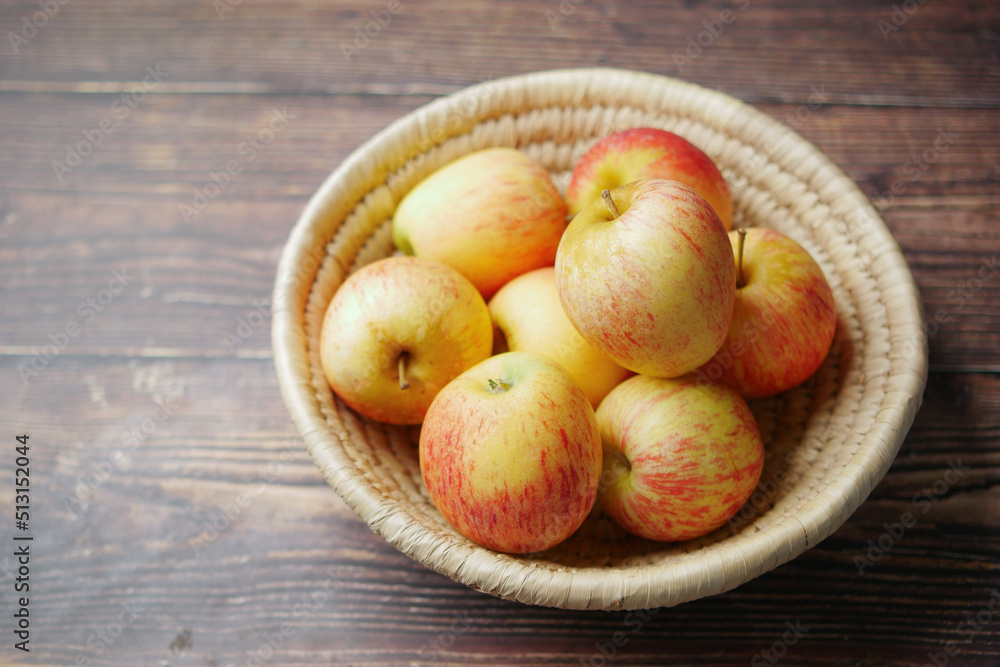 Close up of fresh apple in a bowl on wooden table Close up of fresh apple in a bowl on wooden table