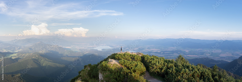 Man standing on the top of the mountain enjoying the views on valley beneath him, Slovakia, Europe
